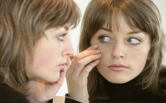 Woman Looking into Mirror